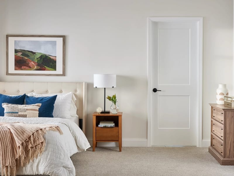 A white two-panel interior door in a bedroom